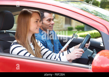 Woman Having Driving Lesson With Instructor Stock Photo