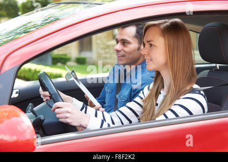 Woman Having Driving Lesson With Instructor Stock Photo