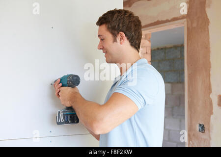 Builder Using Power Tool On Site Stock Photo
