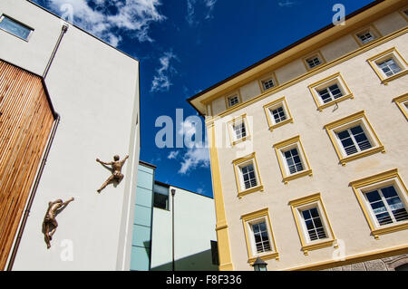 Climbing a building scene from the town center of Ortisei (St. Ulrich) in the Dolomites, Italy Stock Photo