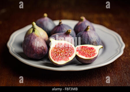 Fresh figs cut on a plate, close up, selective focus Stock Photo