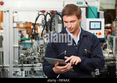 Engineer In Factory Using Digital Tablet Stock Photo