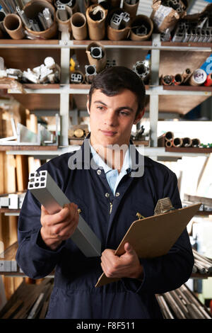 Factory Worker In Store Room With Components Stock Photo