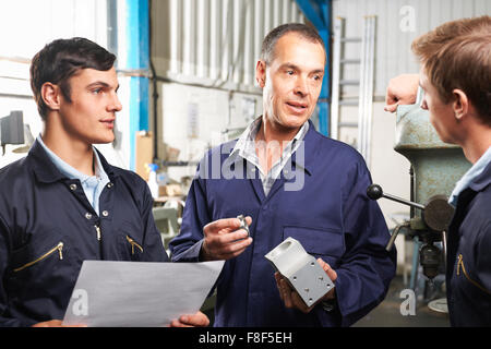 Team Of Engineers Having Discussion In Factory Stock Photo