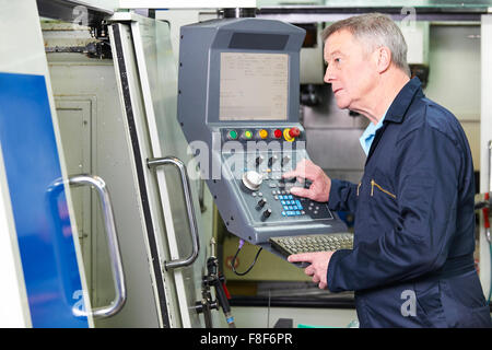 Engineer Operating Computer Controlled Cutting Machine Stock Photo