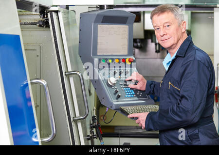 Engineer Operating Computer Controlled Cutting Machine Stock Photo