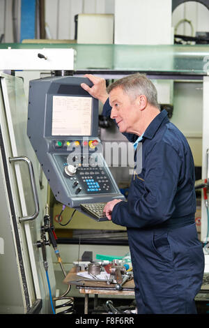 Engineer Operating Computer Controlled Cutting Machine Stock Photo