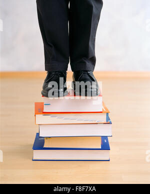 man on a bookpile Stock Photo