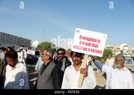 Citizens and NAB employees are holding awareness walk on the occasion of International Anti Corruption Day, passing through the road near Sea View organized by National Accountability Bureau in Karachi on Wednesday, December 09, 2015. Stock Photo