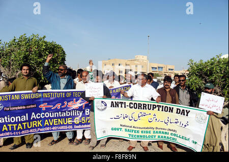 Citizens and NAB employees are holding awareness walk on the occasion of International Anti Corruption Day, passing through the road near Sea View organized by National Accountability Bureau in Karachi on Wednesday, December 09, 2015. Stock Photo