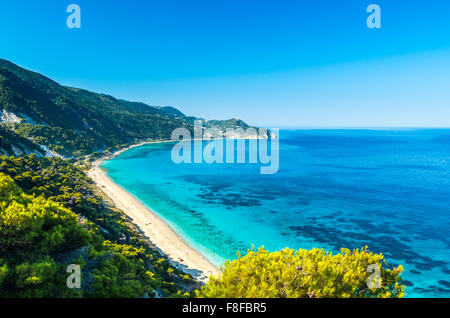 Agios Nikitas beach in Lefkada Island, Greece - Ionian Islands. In the background it is visible the village of Agios Nikitas. Stock Photo