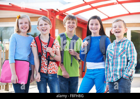 Portrait Of School Pupils Outside Classroom Carrying Bags Stock Photo