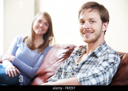 Happy Young Couple Relaxing At Home Stock Photo