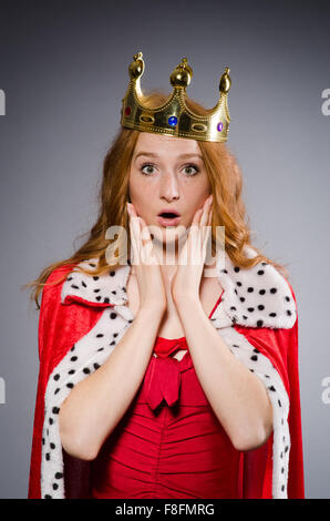 Pretty young queen in red dress isolated on white Stock Photo