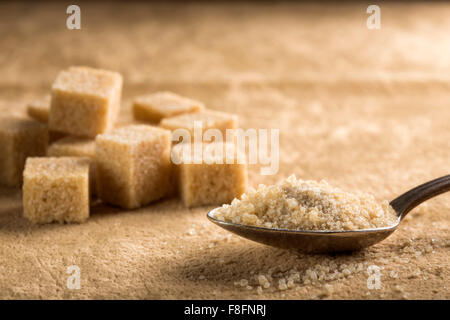 Brown sugar in spoon and sugar cubes Stock Photo