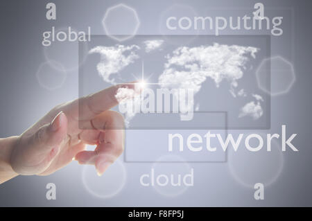 Finger pressing touch screen with cloud world map Stock Photo