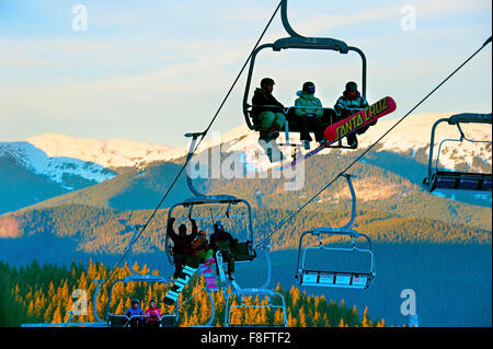 People on a ski lift in Bukovel. Bukovel is the most popular ski resort in Ukraine. Stock Photo