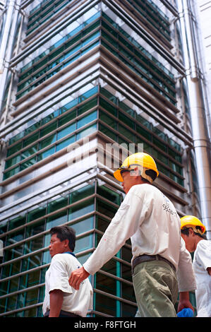Workers walking in front of Kuala Lumpur Twin Towers. Stock Photo