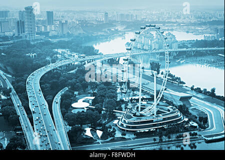 Skyline of Singapore with famous Singapore Flyer - the Largest Ferris Wheel in the World Stock Photo