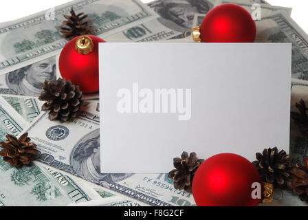 Christmas tree cones, red balls and card on the background of hundred dollar bills Stock Photo