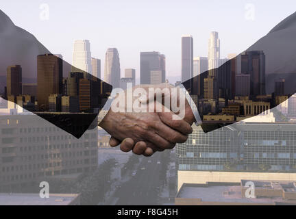 Businessmen Shaking Hands Over Los Angeles Stock Photo