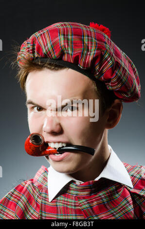 Funny scotsman smoking pipe tobacco Stock Photo