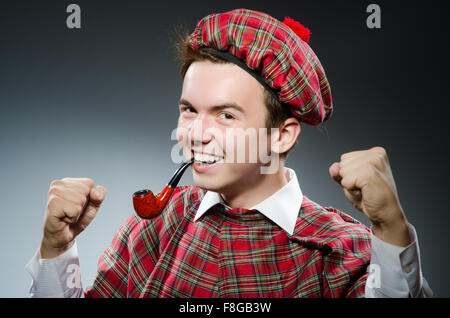 Funny scotsman smoking pipe tobacco Stock Photo