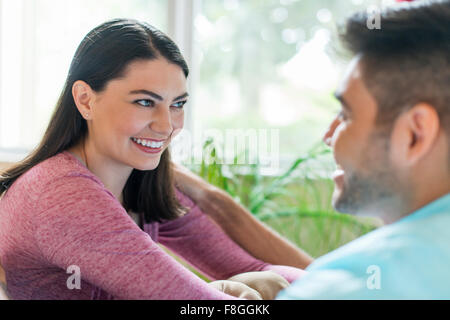 Hispanic couple talking indoors Stock Photo
