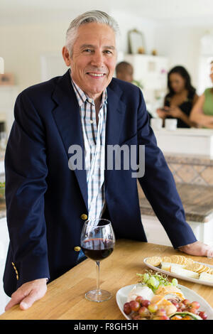 Caucasian man drinking wine at party Stock Photo