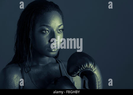 African American woman wearing boxing gloves Stock Photo