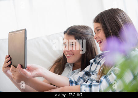 Caucasian twin sisters using digital tablet Stock Photo