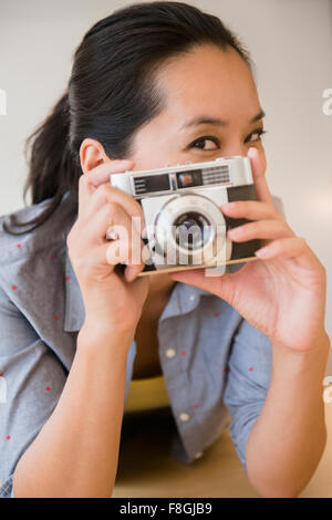 Chinese woman using vintage camera Stock Photo