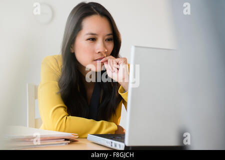 Chinese businesswoman using laptop Stock Photo
