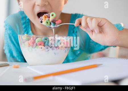 Girl eating bowl of cereal Stock Photo