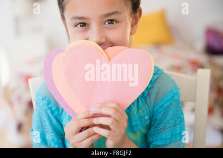 Girl holding paper hearts Stock Photo