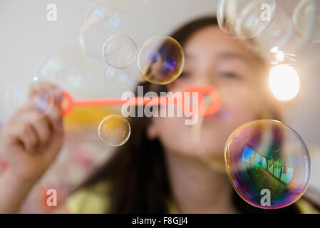 Girl blowing bubbles Stock Photo