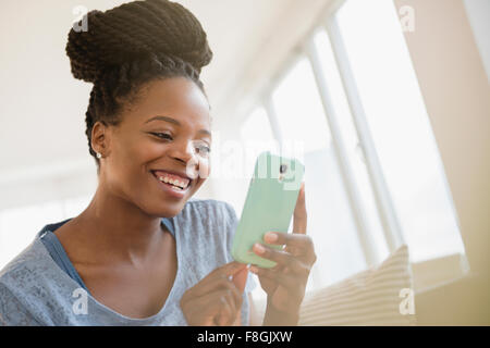 Black woman using cell phone Stock Photo