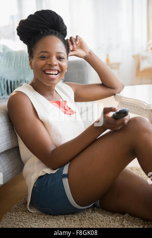 Black woman watching television Stock Photo