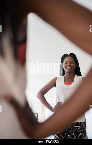Black woman admiring herself in mirror Stock Photo