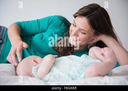 Mother playing with baby daughter Stock Photo