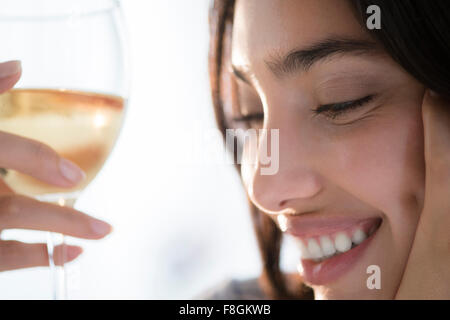 Hispanic woman holding glass of wine Stock Photo