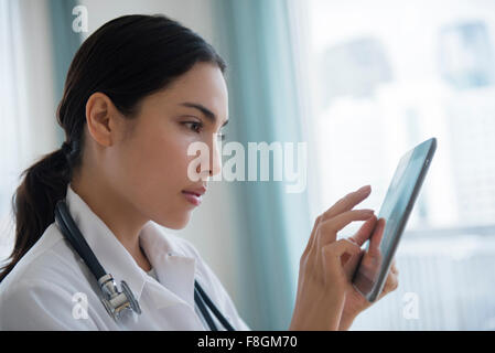 Hispanic doctor using digital tablet Stock Photo