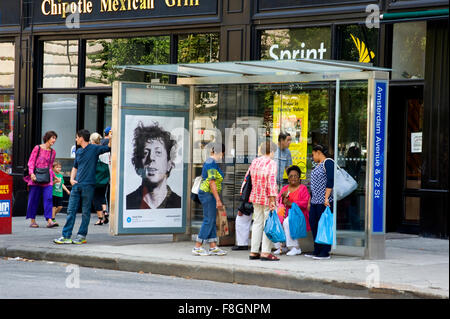 A Chuck Close painting is reproduced on an advertising panel at a bus shelter in New York City during the Art Everywhere event. Stock Photo