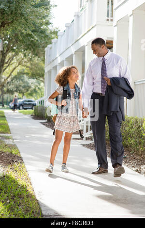 Father walking daughter to school Stock Photo