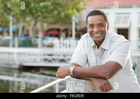 Black man smiling at marina Stock Photo
