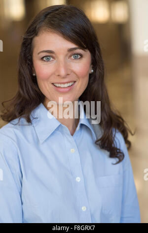 Caucasian woman smiling indoors Stock Photo