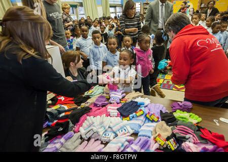 Detroit, Michigan USA. 9th December 2015. Children at Dossin Elementary School receive mittens from a charity called Mittens for Detroit. The charity is distributing mittens to 26,000 Detroit Public Schools elementary students; most were donated by employees of Fiat Chrysler Automobiles. Credit:  Jim West/Alamy Live News Stock Photo
