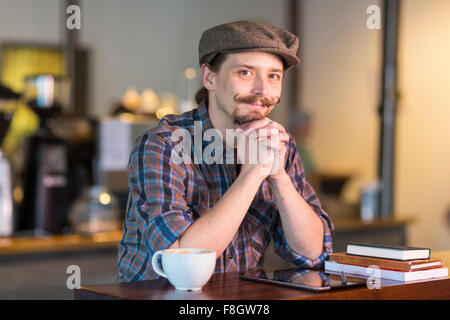 Caucasian man smiling in cafe Stock Photo