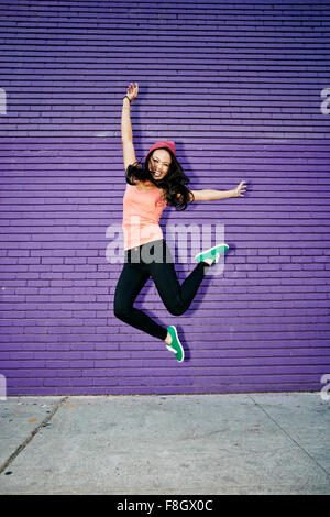 Asian woman jumping for joy Stock Photo