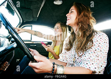 Women driving vintage car
